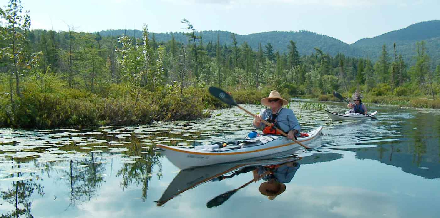 people paddingly canoes on a Clinton County, NY waterway