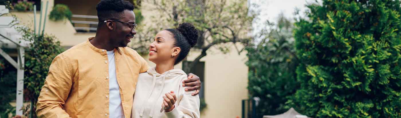 A young couple smile and enjoy purchasing a new home