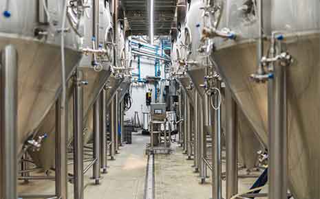 Stainless steel fermentation tanks in a craft brewery