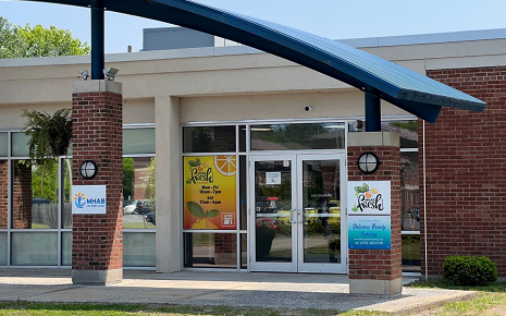 The image shows the entrance to MHAB Fresh, a sandwich shop, convenience store, and community space located on the MHAB Life Skills Campus at 14 Dormitory Drive, Plattsburgh, New York.