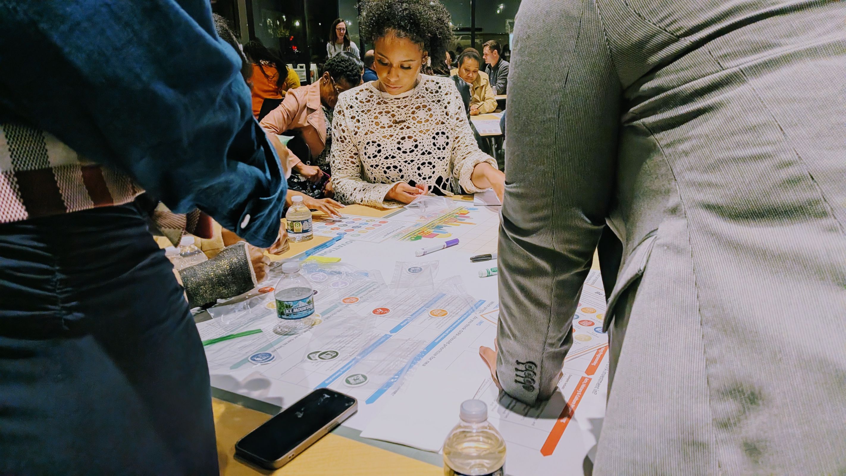 community members looking at document on table, omaha NE