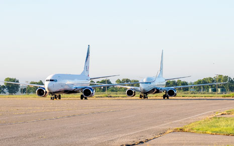 Two plans on the runway at Ardmore Industrial Airport, in Ardmore, OK