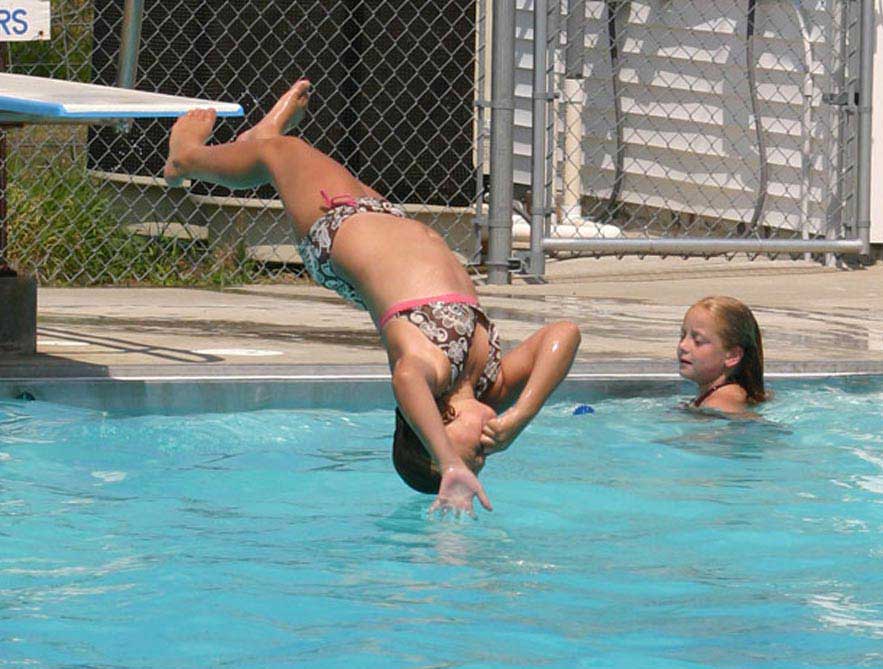 children diving and playing in the community pool