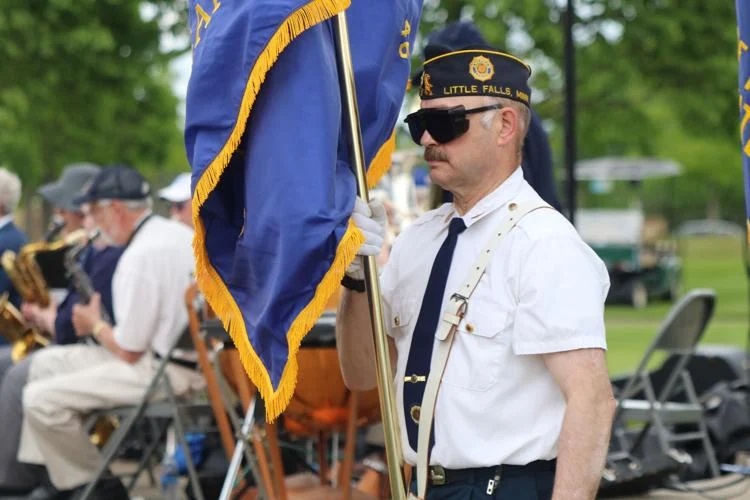 A veteran from the Little Falls American Legion Post 46 carries a flag during a Memorial Day ceremony at the Minnesota State Veteran's Cemetery in Little Falls. by Jeff Hage / Morrison County Record