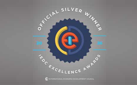 The image shows an official silver winner badge for the International Economic Development Council (IEDC) Excellence Awards.