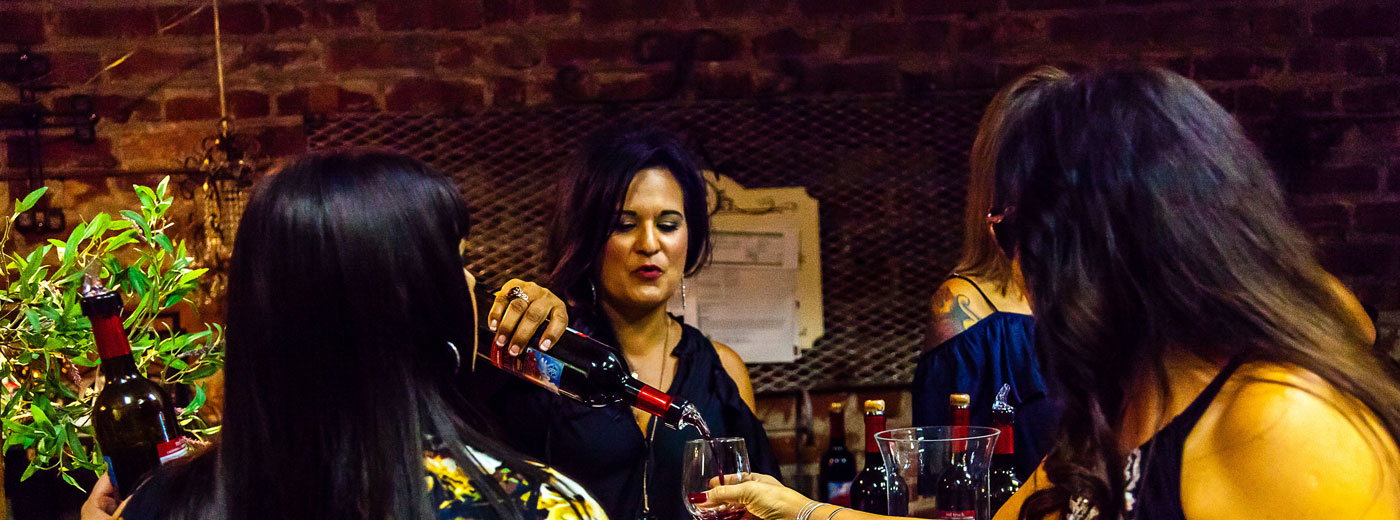 lady pouring wine at wine tasting