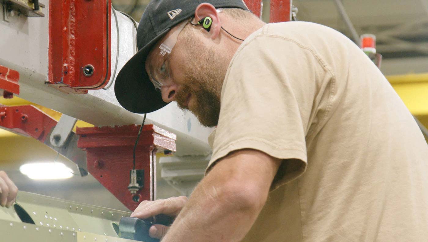 man working with cutting machinery