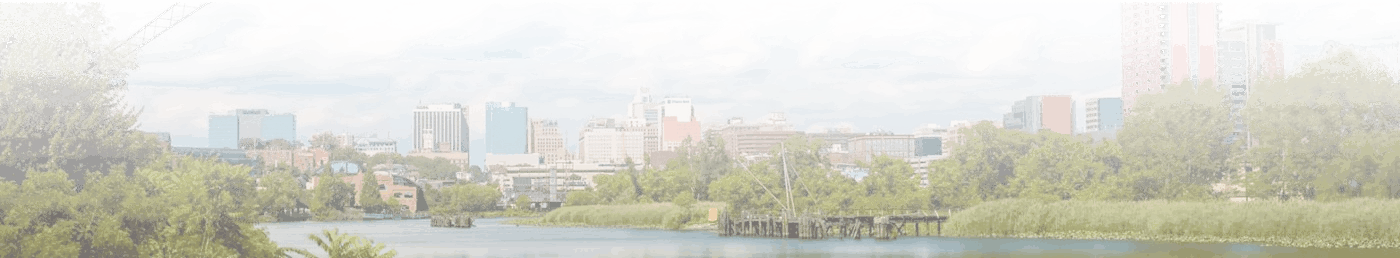 Background image of Wilmington, Delaware that showcases the Delaware feeding into the city proper with a fading effect on the image itself.